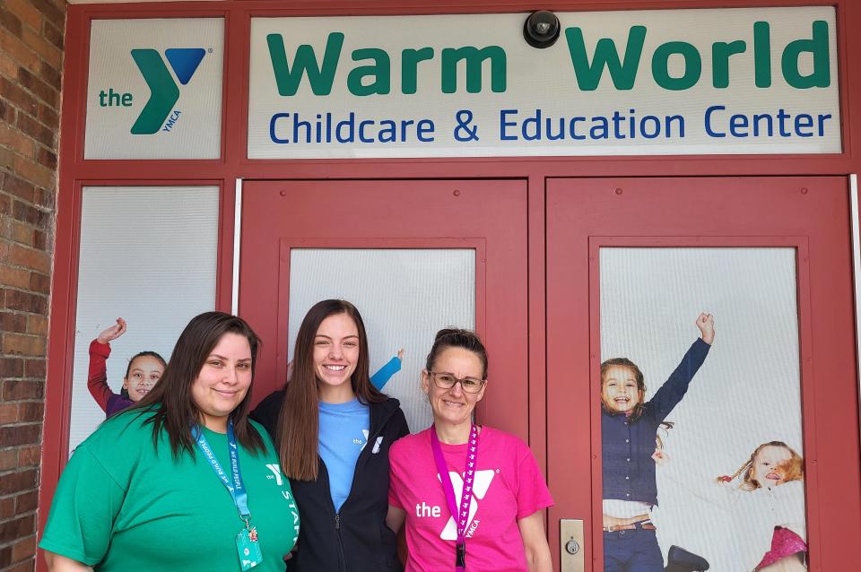 Shanna Graham, early childcare director, left, Adrianna McGarvie, lead teacher in the fox den, a space for 4-year-olds, and office coordinator Janet Kamsickas are pictured on Thursday, June 8, 2023, at the entrance of the YMCA's Warm World Childcare and Education Center. Kamsickas said they started registering kids Wednesday and were set to open June 18.