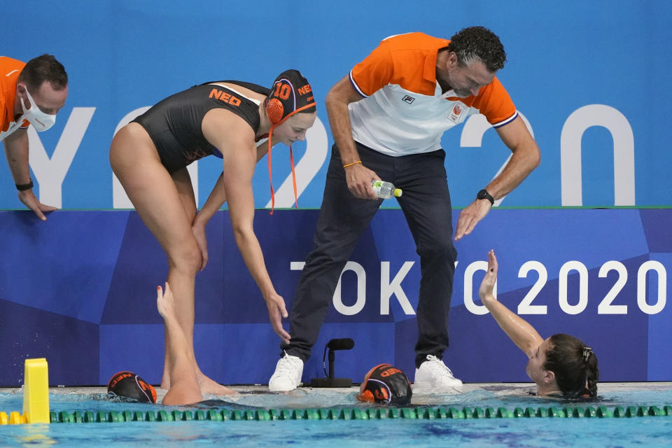 Netherlands head coach Arno Havenga congratulates his players after a 33-1 win over South Africa in a preliminary round women's water polo match at the 2020 Summer Olympics, Friday, July 30, 2021, in Tokyo, Japan. (AP Photo/Mark Humphrey)