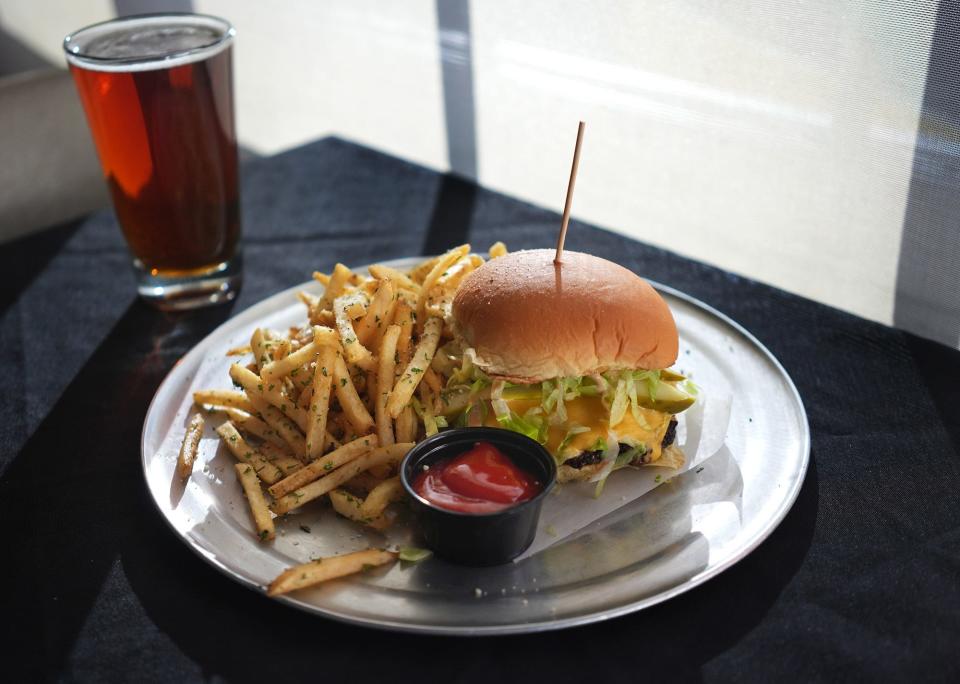 Smash burger with fries and a Great Lakes beer photographed at Ash & Em, 541 S. High St.