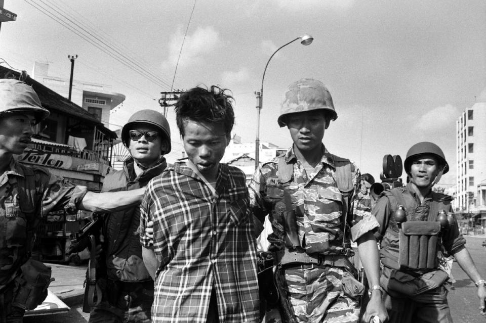 South Vietnamese forces escort suspected Viet Cong officer Nguyen Van Lem on a Saigon street Feb. 1, 1968. (AP Photo/Eddie Adams)
