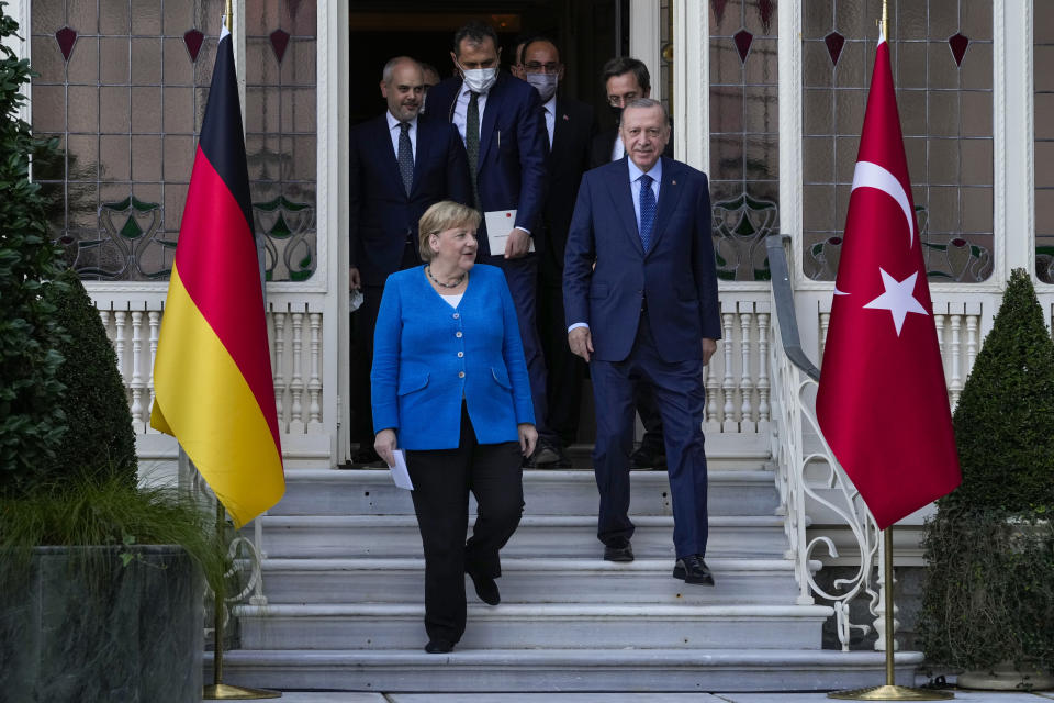 German Chancellor Angela Merkel, front left, and Turkey's President Recep Tayyip Erdogan, front right, arrive for a joint news conference following their meeting at Huber vila, Erdogan's presidential resident, in Istanbul, Turkey, Saturday, Oct. 16, 2021. The leaders discussed Ankara's relationship with Germany and the European Union as well as regional issues including Syria and Afghanistan. (AP Photo/Francisco Seco)