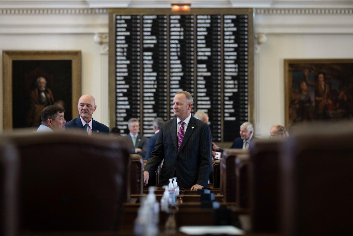 State Rep. Four Price, R-Amarillo (center), speaks with legislators before the House gavels in on Aug. 31, 2021.