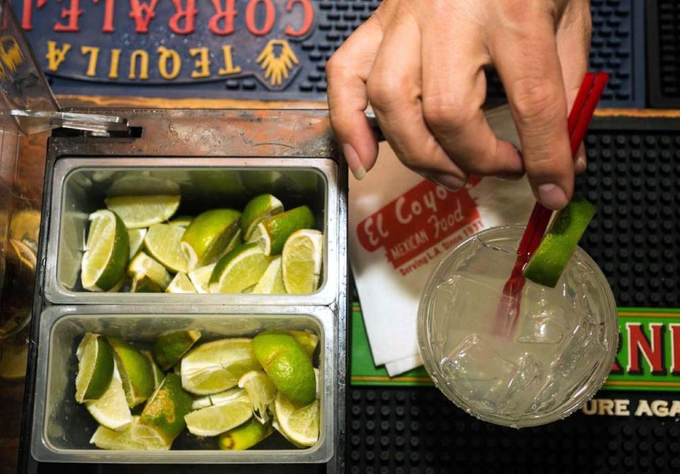 In this Monday, April 28, 2014 photo, bartender Mario Sanchez crafts a margarita cocktail at the bar of El Coyote, a Mexican restaurant in Los Angeles. Thousands of restaurateurs from coast to coast who have fallen victim to the Great Green Citrus Crisis of 2014. The lime, that humble little fruit that sort of resembles a green golf ball, has skyrocketed in price in recent weeks, quadrupling or, in some areas, going even higher. (AP Photo)