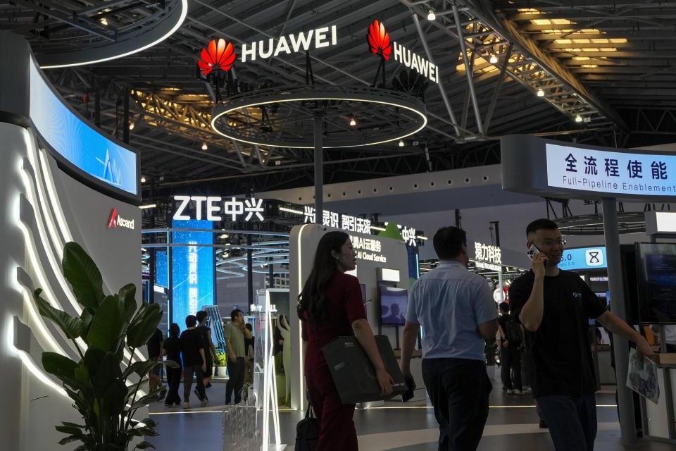 Visitors tour the Huawei and ZTE exhibition booths during the 2024 World Artificial Intelligence Conference (WAIC) & High-Level Meeting on Global AI Governance with the themed "Governing AI for Good and for All" at the Shanghai Expo Center Multifunction Hall in Shanghai, China on July 4, 2024. Germany will bar the use of components made by Chinese companies Huawei and ZTE from core parts of the country's 5G networks, in two steps starting in 2026, the nation's top security official said Thursday, July 11, 2024. (AP Photo/Andy Wong)