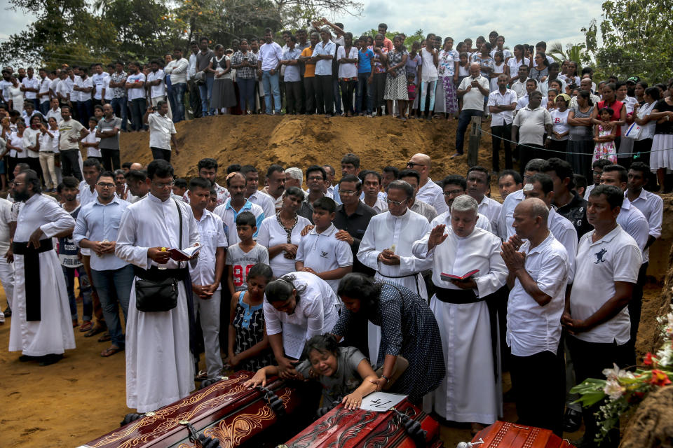 A woman weeps next to coffins during a funeral near St. Sebastian's Church in Negombo, Sri Lanka, April 23, 2019. (Athit Perawongmetha / Reuters)