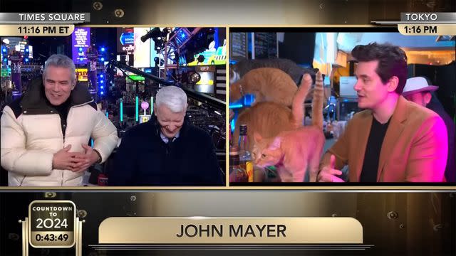 <p>CNN/Youtube</p> Anderson Cooper can't stop laughing as John Mayer video-calls from a cat bar in Tokyo.