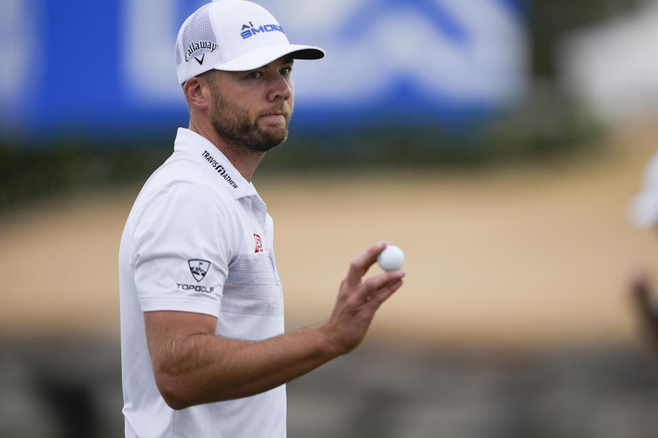 Sam Burns acknowledges the gallery on 18th green on the Pete Dye Stadium Course at PGA West during the third round of The American Express golf tournament Saturday, Jan. 20, 2024, in La Quinta, Calif. (AP Photo/Ryan Sun)