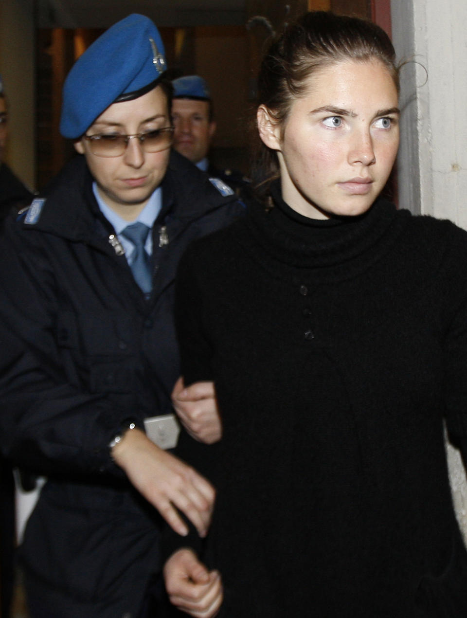 File- This Dec. 1, 2009 file photo shows U.S. murder suspect Amanda Knox being accompanied by a police penitentiary officer as she arrives for a hearing at the Perugia court, Italy. To many Americans, especially in her hometown of Seattle, Amanda Knox seems the victim, unfairly hounded by a capricious foreign legal system for the death of a 21-year-old British woman. But in Italy and elsewhere in Europe, others see her as someone who got away with murder, embroiled in a case that continues to make global headlines and reinforces a negative image of Americans behaving badly, even criminally, abroad without any punishment. As she remains free in the U.S., these perceptions will not only fuel the debate about who killed Meredith Kercher in 2007 and what role, if any, Knox played in her death, but also about whether U.S. authorities should, if asked, send her to Italy to face prison. (AP Photo/Luca Bruno, File)