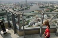 A girl plays with her hair in the wind on the observation point at the tallest building in Yekaterinburg, Russia June 28, 2018. REUTERS/Damir Sagolj