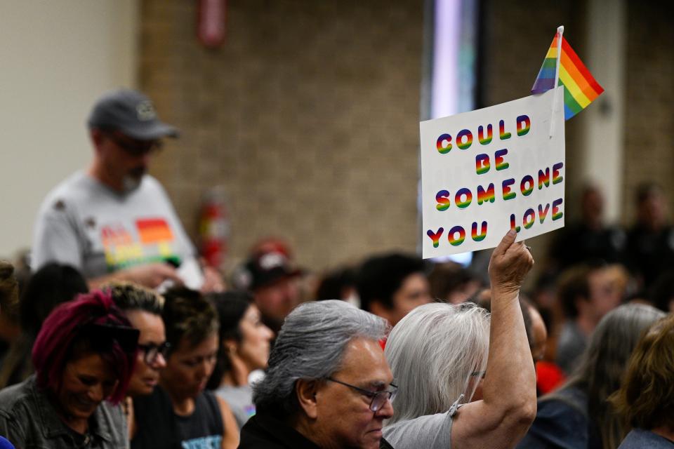 Parents, students, and staff of Chino Valley Unified School District hold up flags and signs in favor of protecting LGBTQ+ policies at the school board meeting held at Don Antonio Lugo High School on Thursday, June 15, 2023, in Chino, Calif.