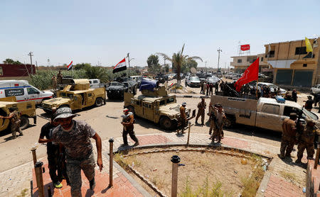 Iraqi security forces gather with Shi'ite fighters in the town of Garma, Iraq, May 26, 2016. REUTERS/Thaier Al-Sudani