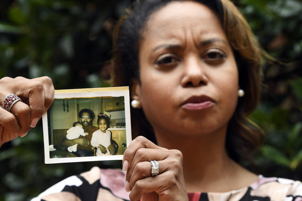 In this Sept. 6, 2019, photo, Donna Cryer holds up family photos that include her father Roland Henry, as she poses for a photo in Washington. When her father died, she tried to donate his organs, yet the local organ collection agency said no, without talking to the family or providing a reason. "It was devastating to be told there was nothing they considered worthy of donation. Nada. Not a kidney, not a liver, not tissue,” recalled Donna Cryer, president of the nonprofit Global Liver Institute and herself a recipient of a liver transplant. (AP Photo/Susan Walsh)