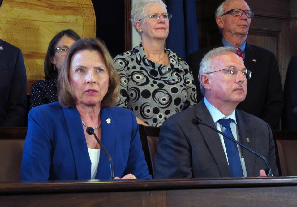 FILE - Then-Alaska Senate President Cathy Giessel, left, a Republican, and then-House Speaker Bryce Edgmon, seated right, an Independent, attend a news conference at the Capitol, May 28, 2019, in Juneau, Alaska. A successful ballot initiative passed by Alaska voters in 2020 would end party primaries and send the top four vote-getters, regardless of party affiliation, to the general election, where ranked-choice voting would determine a consensus winner. The Alaska Supreme Court is set to hear a challenge to the system Tuesday, Jan. 18, 2022. (AP Photo/Becky Bohrer, File)