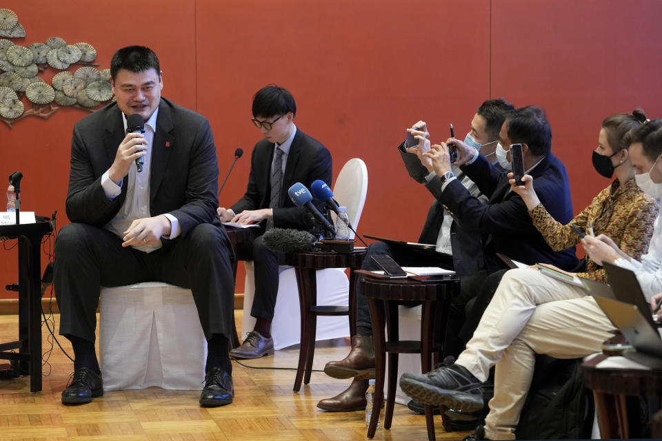 Reporters use smartphones to film Yao Ming, head of the Chinese Basketball Association and Ice Snow Sports Promotion Ambassador, left, as he speaks during a Linjia 7 Salon afternoon tea with journalists at Beijing International Club in Beijing, Monday, Jan. 17, 2022. Former NBA great Yao Ming said Monday he and others had a pleasant talk when they met last month with Chinese tennis player Peng Shuai, whose disappearance after making a sexual assault allegation against a former government official raised international concern. (AP Photo/Andy Wong)