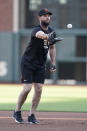 San Francisco Giants' Brandon Belt tosses a ball with his gloved hand during a baseball practice in San Francisco, Tuesday, Oct. 5, 2021. (AP Photo/Jeff Chiu)
