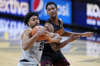 FILE - In this Feb. 25, 2021, file photo, Colorado forward Evan Battey, left, pulls in a rebound as Souther California forward Evan Mobley defends in the first half of an NCAA college basketball game in Boulder, Colo. (AP Photo/David Zalubowski, File)