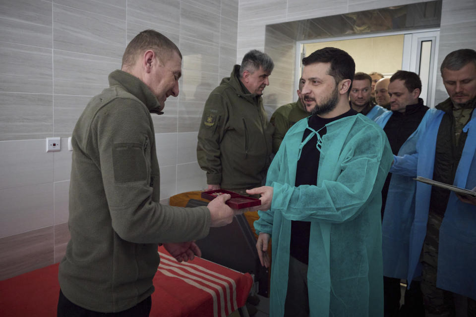 In this photo provided by the Ukrainian Presidential Press Office, Ukrainian president Volodymyr Zelenskyy awards a soldier in hospital in Donetsk region, Ukraine, Wednesday, March 22, 2023. (Ukrainian Presidential Press Office via AP)