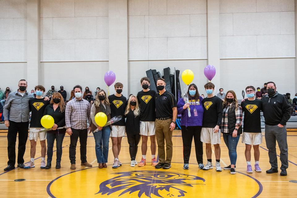 Rhinebeck senior basketball players and their parents pose for a portrait before taking on Onteora Friday in Rhinebeck.