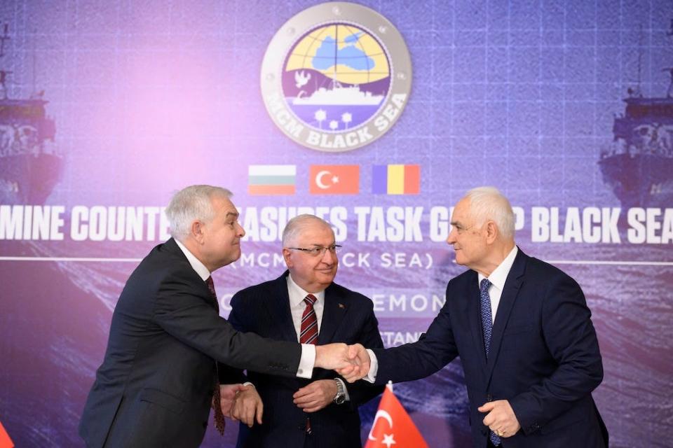 Turkish Defense Minister Yasar Guler (C), Romanian Defense Minister Angel Tilvar (L) and Bulgaria's Deputy Defense Minister Atanas Zapryanov (R) shake hands after signing an agreement on demining the Black Sea to ensure safe waters after Russia's war in Ukraine, in Istanbul, on January 11, 2024.