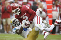 Oklahoma wide receiver CeeDee Lamb (2) catches a pass and is immediately tackled by UCLA defensive back Adarius Pickett (6) in the first quarter of an NCAA college football game in Norman, Okla., Saturday, Sept. 8, 2018. (AP Photo/Sue Ogrocki)