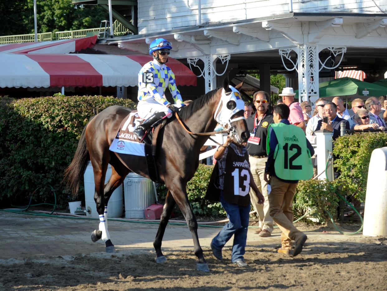 Laoban with Jose Ortiz aboard during the post parade before The Travers Stakes horse race at Saratoga Race Course in Saratoga Springs, N.Y., Saturday, Aug. 27, 2016. (AP Photo/Hans Pennink)