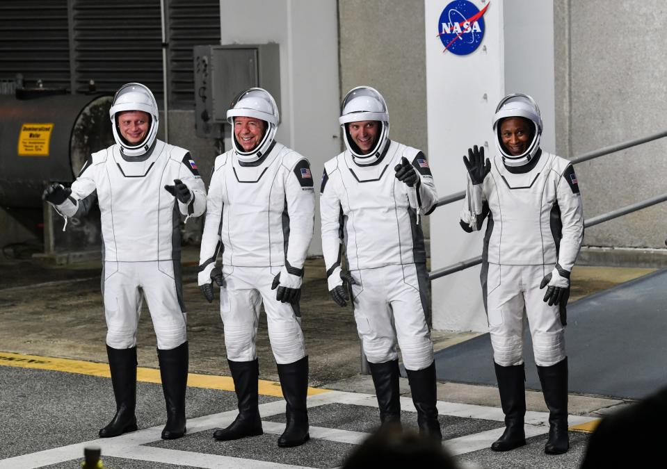 Crew-8 astronauts Alexander Grebenkin, Michael Barrett, Matthew Dominick and Jeanette Epps wave to media as they head to the launch pad Sunday.