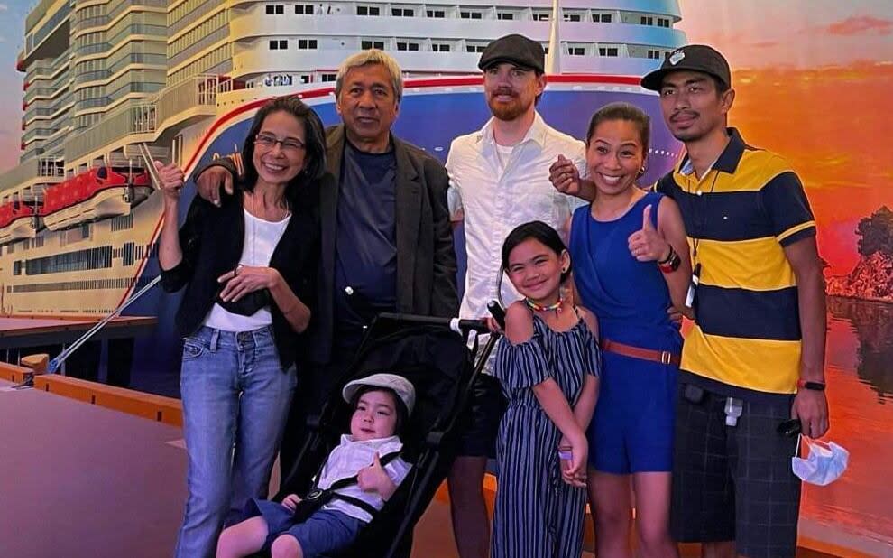 Alva Bourque, in blue, with husband, Robert, in white, pose with Alva's extended family during a cruise. (Alva Bourque - image credit)