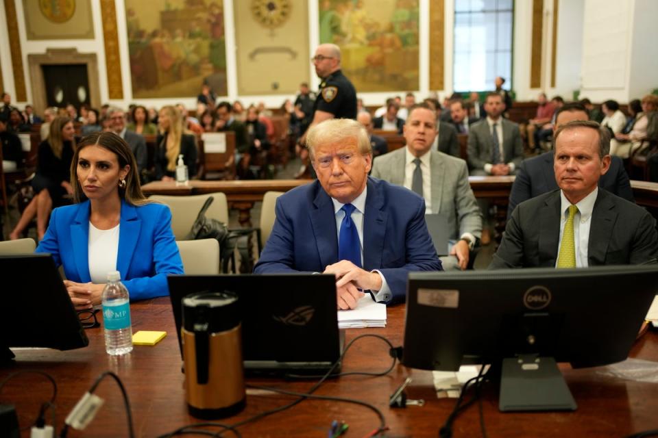Donald Trump sits with his attorneys Alina Habba, left, and Christopher Kise, right, in New York Supreme Court on 25 October. (EPA)