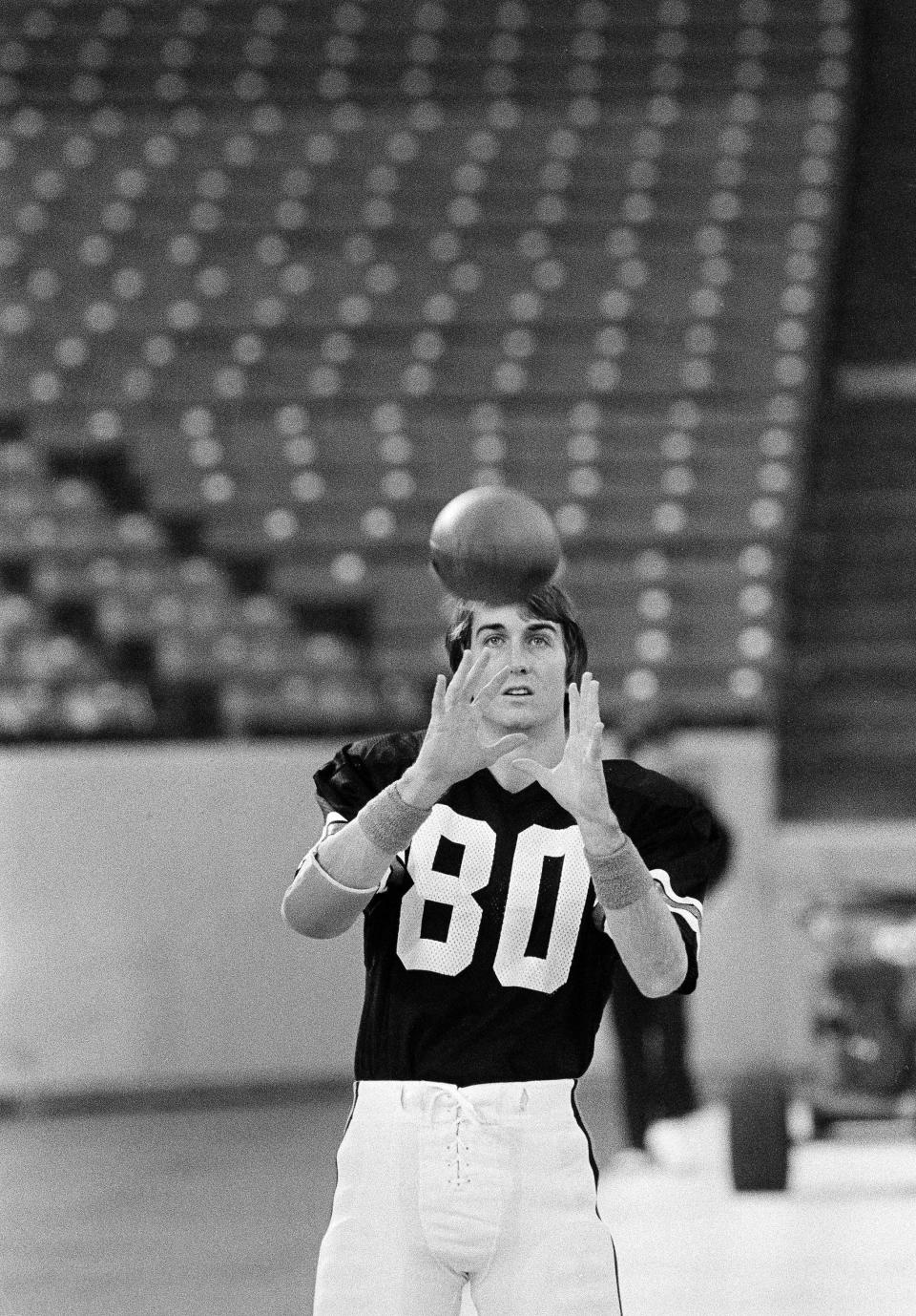 Cris Collinsworth, wide receiver for the Cincinnati Bengals, practices his pass-catching during the teams' workout at the Silverdome in Pontiac, Mich., Jan. 20, 1982.