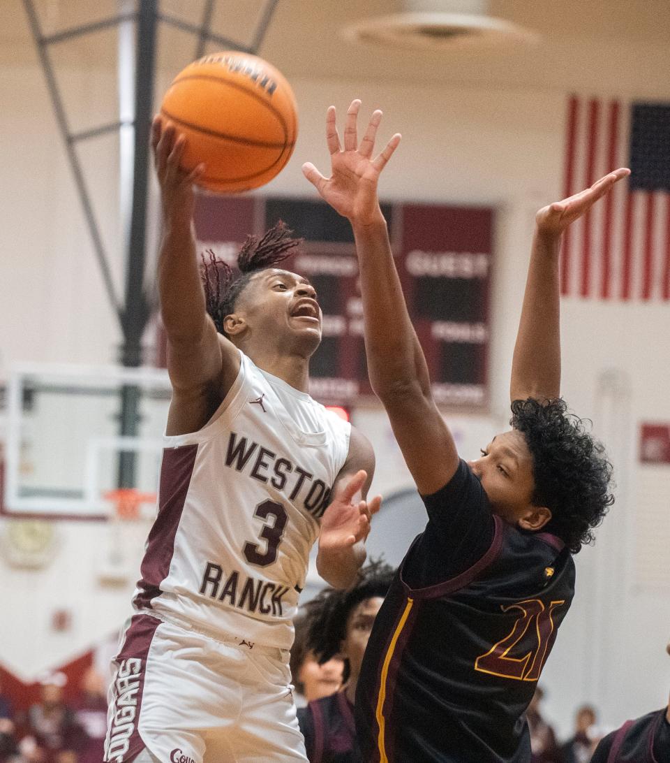 Weston Ranch's Elliot Mobley, left, goes to the hoop during a boys varsity basketball game at Weston Ranch in Stockton on Wednesday, Jan. 4, 2023.