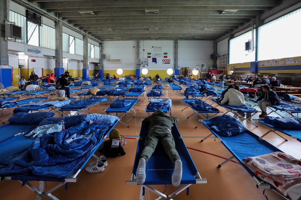 Evacuees rest in a gymnasium in Bologna. (Reuters)