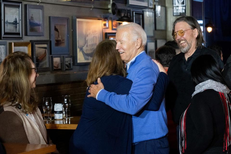 PHOTO: President Joe Biden visits with patrons at the Cedar Lounge Tap Room at Earth Rider Brewery after speaking about the Bipartisan Infrastructure Law at the brewery in Superior, Wis., on Jan. 25, 2024.  (Saul Loeb/AFP via Getty Images)