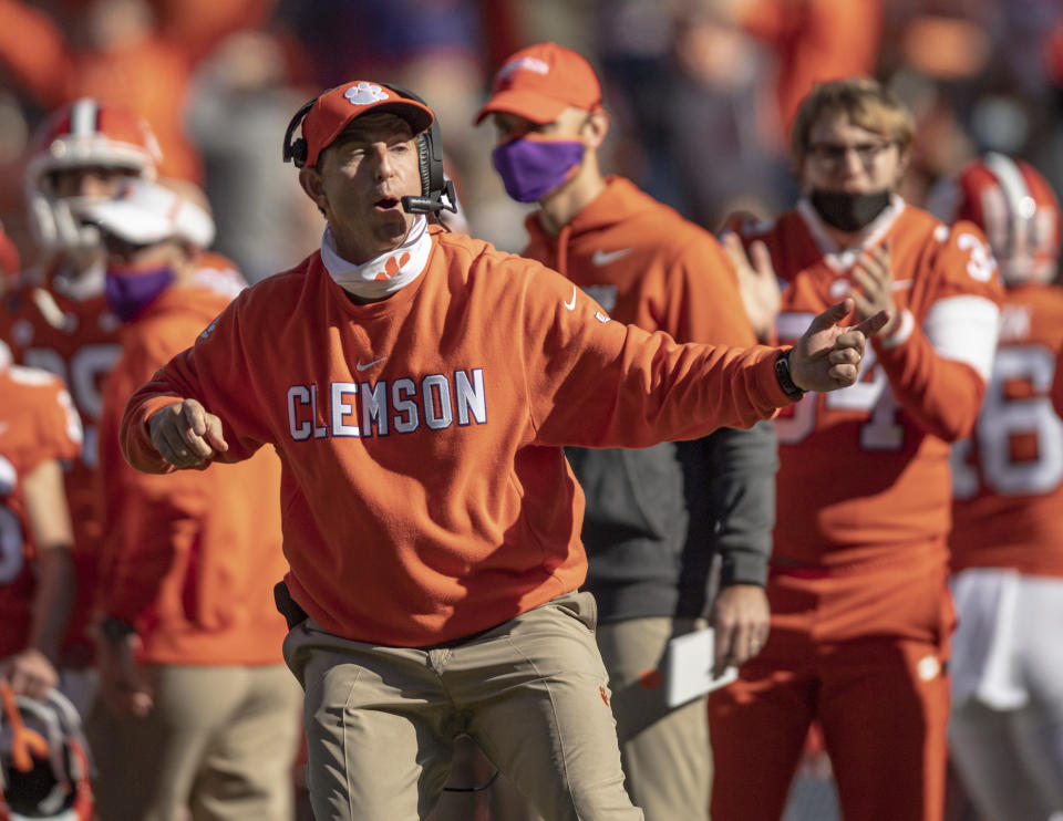 Clemson head coach Dabo Swinney talks with players during the second half of an NCAA college football game Saturday, Oct. 31, 2020, in Clemson, S.C. (Josh Morgan/Pool Photo via AP)