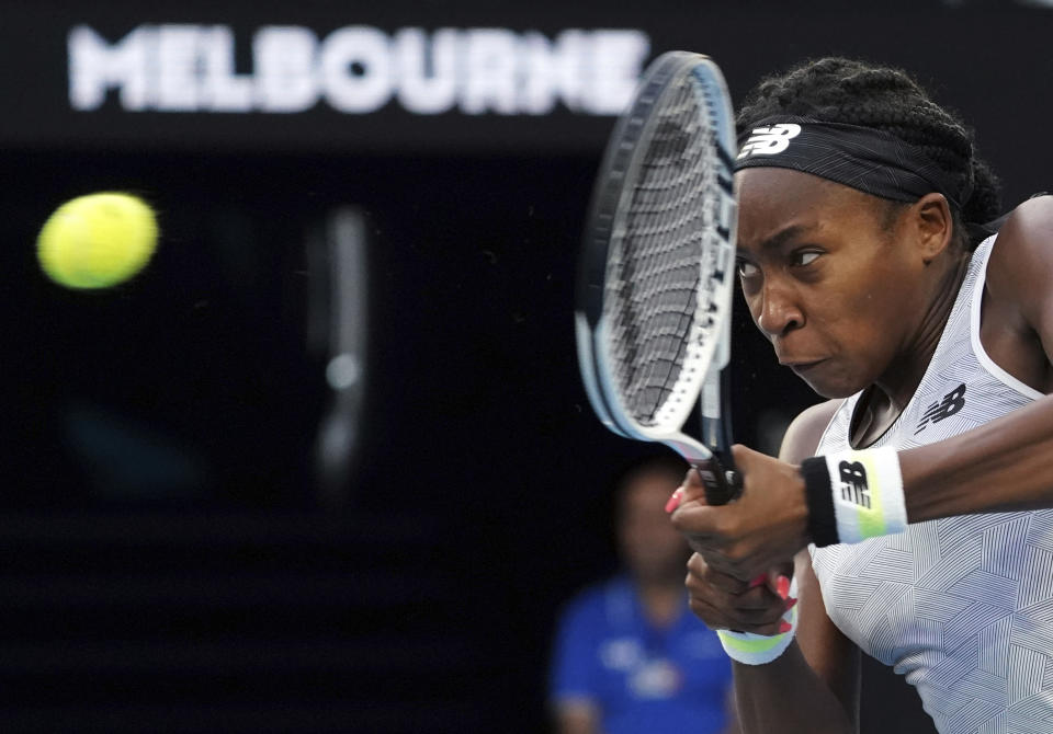 Coco Gauff of the U.S. makes a backhand return to Japan's Naomi Osaka during their third round singles match at the Australian Open tennis championship in Melbourne, Australia, Friday, Jan. 24, 2020. (AP Photo/Lee Jin-man)