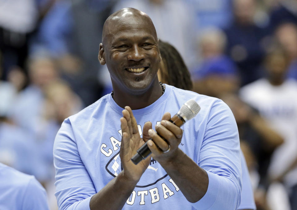 FILE - In this March 4, 2017, file photo, former North Carolina basketball player Michael Jordan applauds during a half-time presentation at an NCAA college basketball game between North Carolina and Duke in Chapel Hill, N.C. Jordan, who played high school basketball in Wilmington, N.C., one of the areas hardest hit by Hurricane Florence, has donated $2 million to assist residents affected by the hurricane. (AP Photo/Gerry Broome, File)