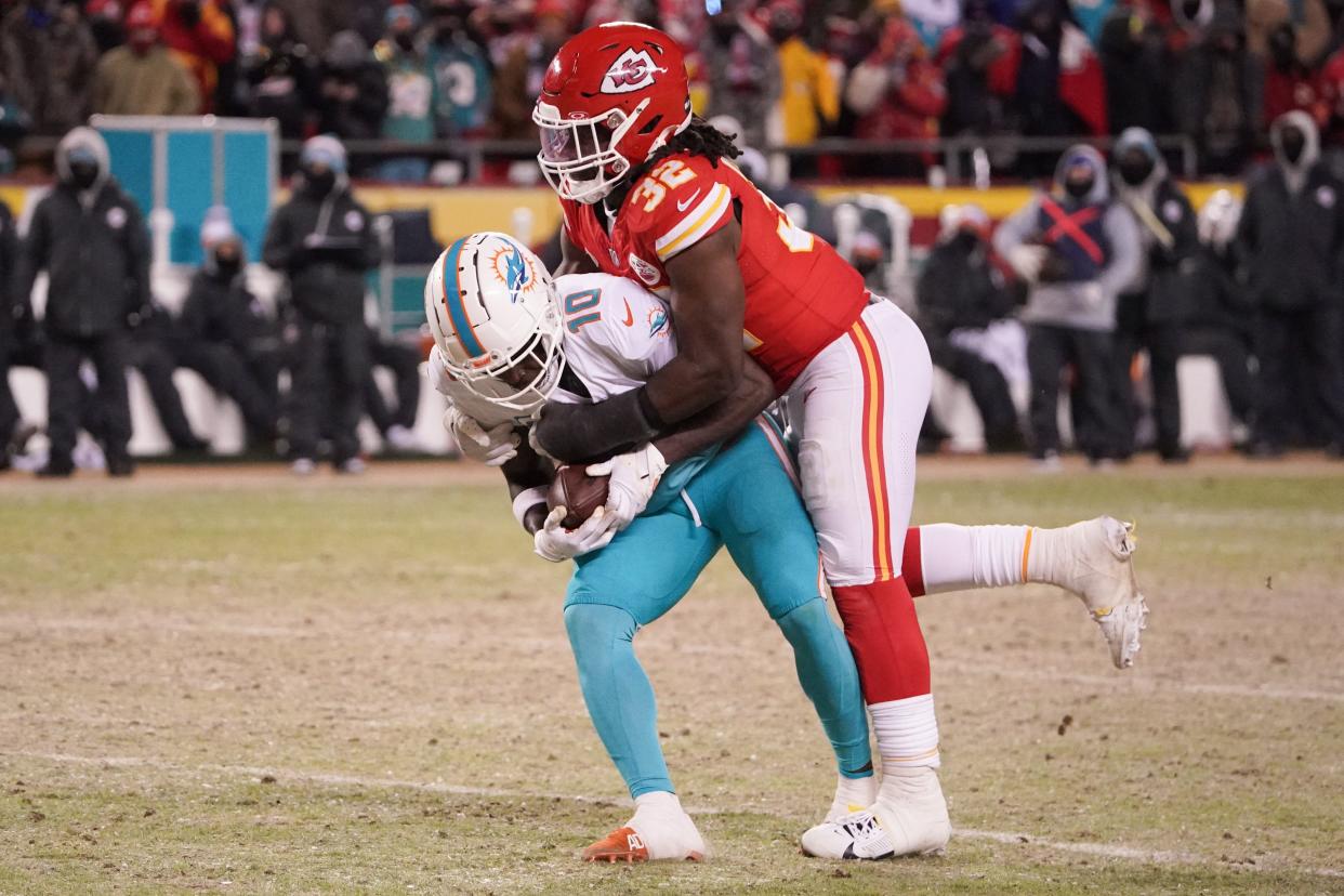 Jan 13, 2024; Kansas City, Missouri, USA; Miami Dolphins wide receiver Tyreek Hill (10) is brought down by Kansas City Chiefs linebacker Nick Bolton (32) during the second half of the 2024 AFC wild card game at GEHA Field at Arrowhead Stadium. Mandatory Credit: Denny Medley-USA TODAY Sports