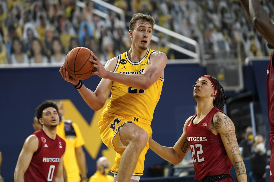 FILE - In this Feb. 18, 2021, file photo, Michigan guard Franz Wagner (21) drives on Rutgers guard Caleb McConnell (22) during an NCAA college basketball game in Ann Arbor, Mich. Wagner is a lottery prospect and one of the top forwards in the NBA draft. (AP Photo/Paul Sancya, File)