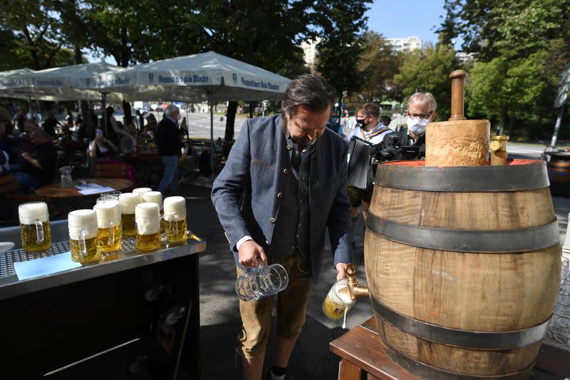Manager of beer garden pours near Theresienwiese where Oktoberfest would have started in Munich