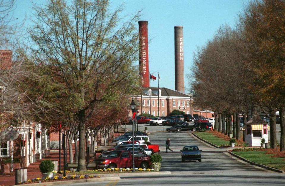 Cannon Mills Co. descendants and Atrium Health signed a settlement agreement resolving all claims and counterclaims in the battle over the family trust, an N.C. Business Court joint motion filed Friday shows. Stacks from Fieldcrest Cannon mills rise above Cannon Village in Kannapolis in this 1999 file photo.