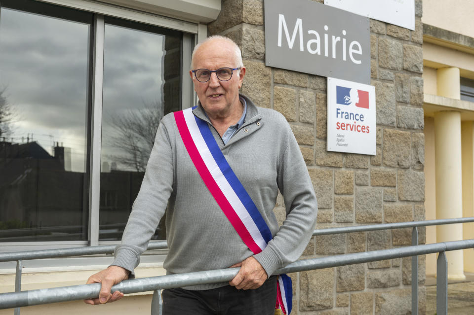Jean-Yves Rolland, mayor of Callac, poses outside the town hall on Dec.15, 2023. The far right cried victory in January 2023, when Rolland gave up his plan to house seven to 10 refugee families. (AP Photo/Mathieu Pattier)