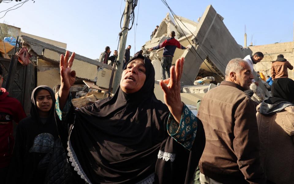 A Palestinian woman reacts in front of the Abu Anza family home destroyed in an overnight Israeli air strike in Rafah in the southern Gaza Strip on March 3, 2024, as the conflict between Israel and the Palestinian militant group Hamas continues