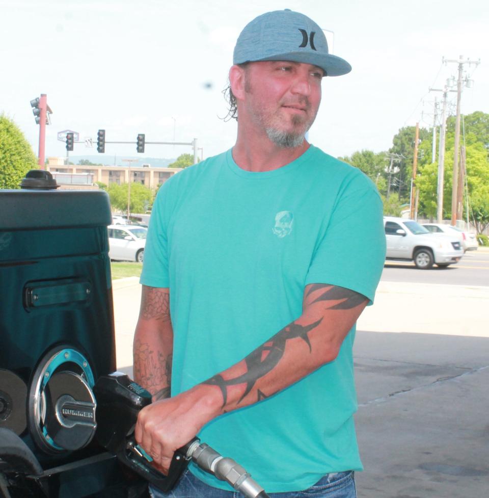 Jody Cantrell, 45, of Van Buren pumps gas in Fort Smith Wednesday, June 1, 2022.