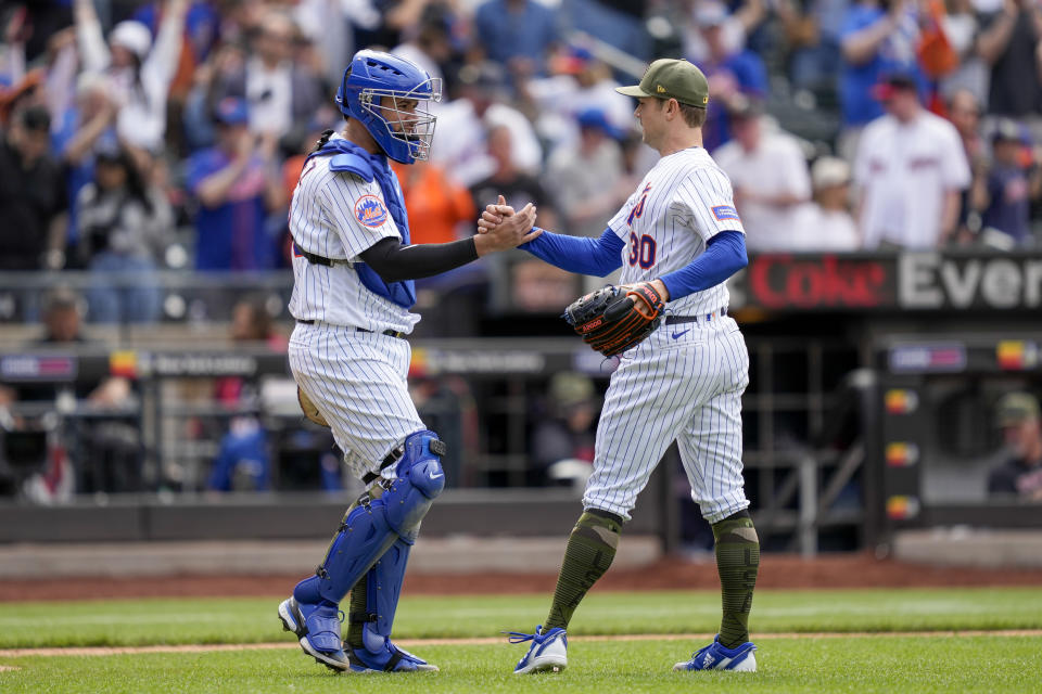 New York Mets catcher Gary Sanchez, left, celebrates with relief pitcher David Robertson (30) after closing the ninth inning of the opener of a split doubleheader baseball game against the Cleveland Guardians, Sunday, May 21, 2023, in New York. (AP Photo/John Minchillo)