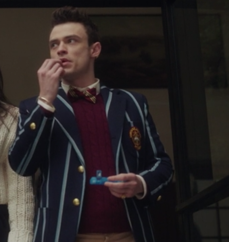 Max wears his pin striped uniform blazer over a knit sweater and a bow tie that matches the sweater