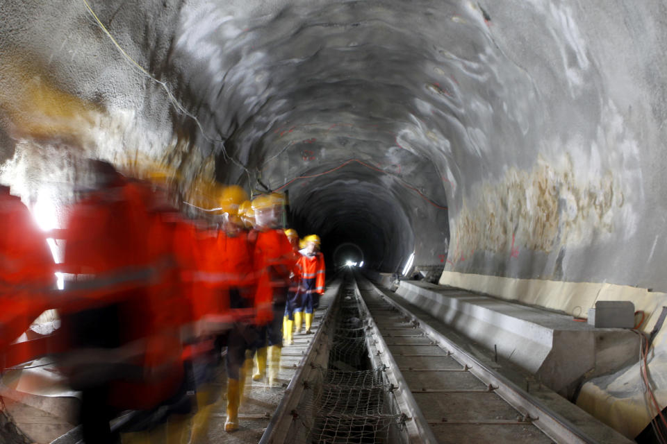 Visitors walk through the construction site of the NEAT Gotthard Base Tunnel at the Erstfeld-Amsteg section