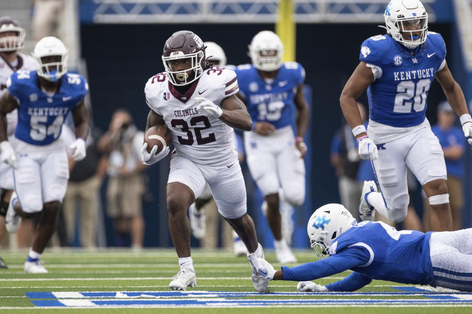 Eastern Kentucky running back Joshua Carter (32) breaks a tackle attempt by Kentucky defensive back Jalen Geiger (4) during the second half of an NCAA college football game in Lexington, Ky., Saturday, Sept. 9, 2023. (AP Photo/Michelle Haas Hutchins)