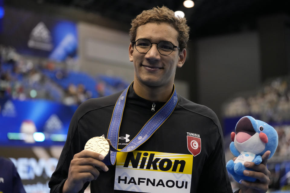 Gold medalist Tunisia's Ahmed Hafnaoui celebrates during the medal ceremony for men's 1500 freestyle at the World Swimming Championships in Fukuoka, Japan, Sunday, July 30, 2023. (AP Photo/Lee Jin-man)