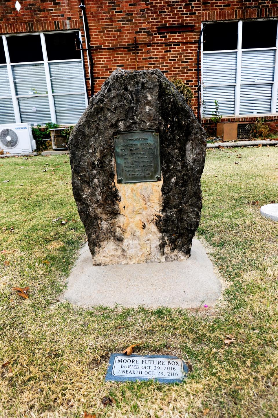 A stone monument and time capsule are pictured Nov. 17 in front of the old Moore High School building.