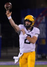 West Virginia quarterback Jarret Doege passes against Kansas during the second quarter of an NCAA college football game Saturday, Nov. 27, 2021, in Lawrence, Kan. (AP Photo/Ed Zurga)