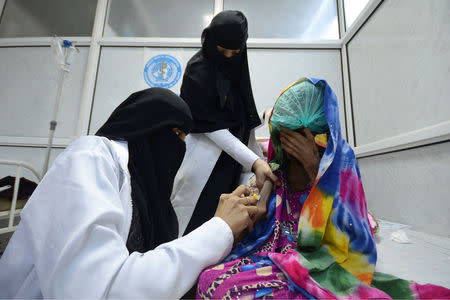 Nurses attend to Saida Ahmad Baghili at the al-Thawra hospital. Baghili is from the small village of Shajn, about 100 km (60 miles) southwest of the city of Hodaida, and used to work with sheep before developing signs of malnutrition five years ago, according to her aunt, Saida Ali Baghili. REUTERS/Abduljabbar Zeyad